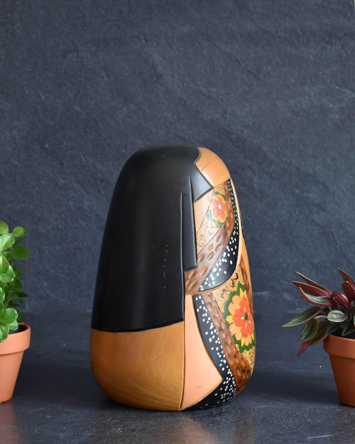 Ishimura Sosaku kokeshi doll showing back view with dark painted hair and wood grain