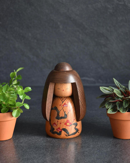 Daisuke Takeda kokeshi doll front view showing painted kimono and wooden hair