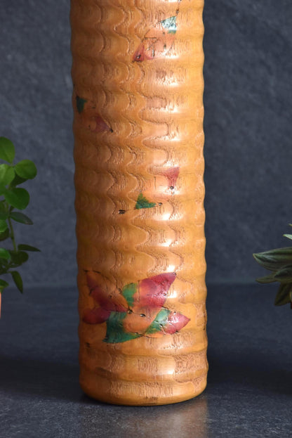 Usaburo Sosaku Kokeshi doll close-up of the hand-painted falling autumn maple leaves pattern