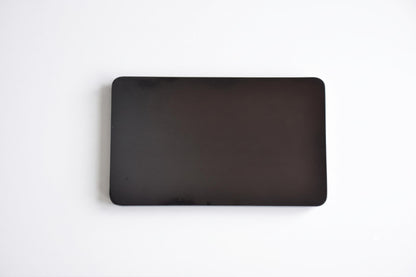 Back of the black lacquer serving tray with silver orchid inlay showing a plain dark finish
