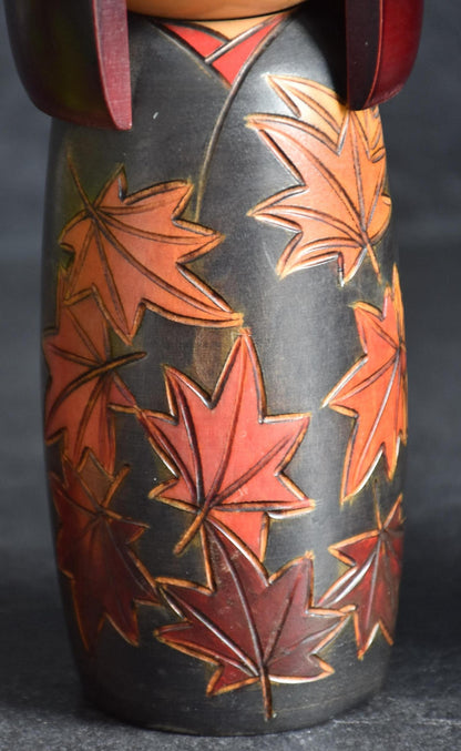 Kohji Sumiya kokeshi doll closeup of carved and hand painted maple leaves pattern
