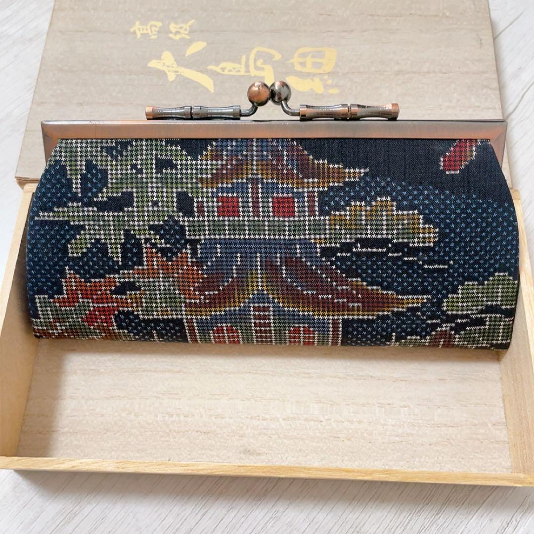 Blue Oshima Tsumugi Silk Gamaguchi Coin Purse front facade showing intricate textile pattern of a traditional building