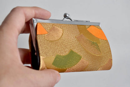 Nishijin-Ori Silk Gamaguchi Coin Purse angled in a hand