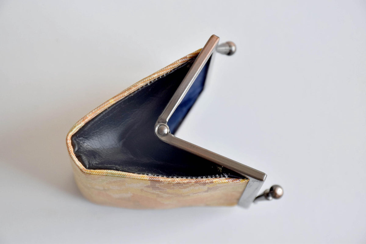 Oshima Tsumugi Silk Gamaguchi Coin Purse viewed from above while open to display the clasp and interior