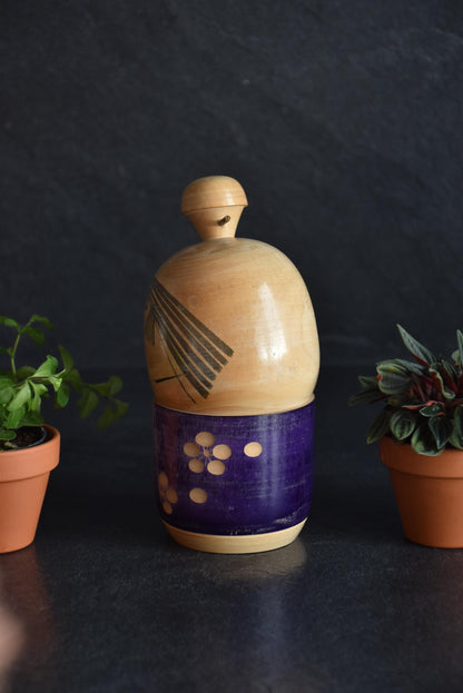 Sato Suigai kokeshi showing the side view with hair and plum blossoms