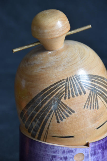Sato Suigai kokeshi showing a detailed view of the finely incised bangs and eyes