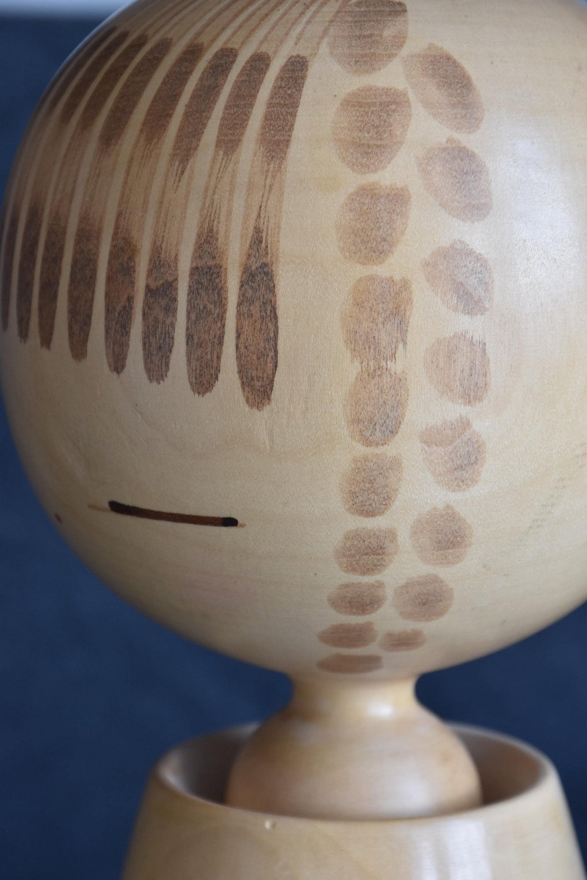 Chiyomatsu Kano kokeshi doll close-up of the painted bangs and facial features