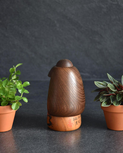 Daisuke Takeda kokeshi doll back view highlighting natural wood grain