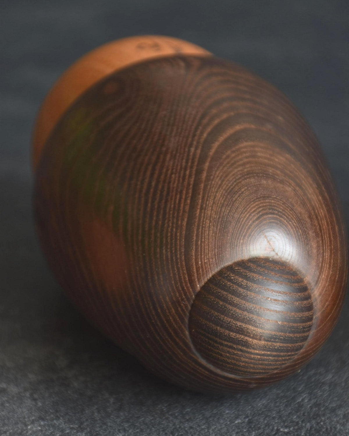 Daisuke Takeda kokeshi doll angled view showing rounded wooden body and grain
