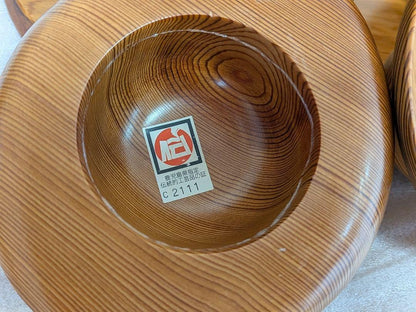 Yakusugi Cedar Sosaku Kokeshi Hat underside showing the wood grain and gold authenticity sticker
