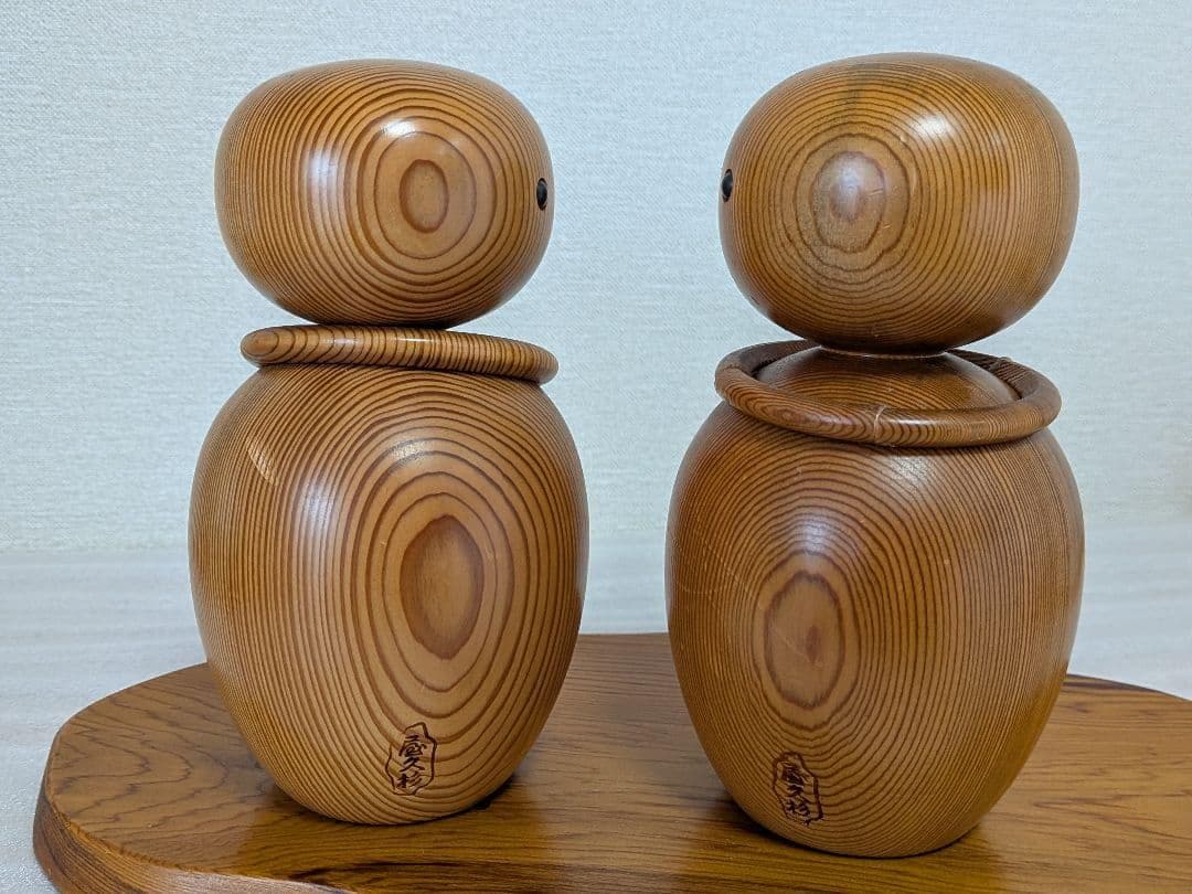 Yakusugi Cedar Sosaku Kokeshi Dolls back view highlighting the carved maker signature stamps