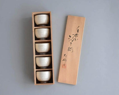 Set Of 5 White Kumidashi Teacups neatly stacked inside the open vertical paulownia wood tomobako box