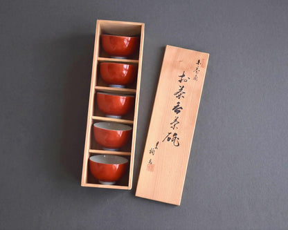 Koransha tea cup set with all five vermilion bowls neatly stacked inside the open wooden box