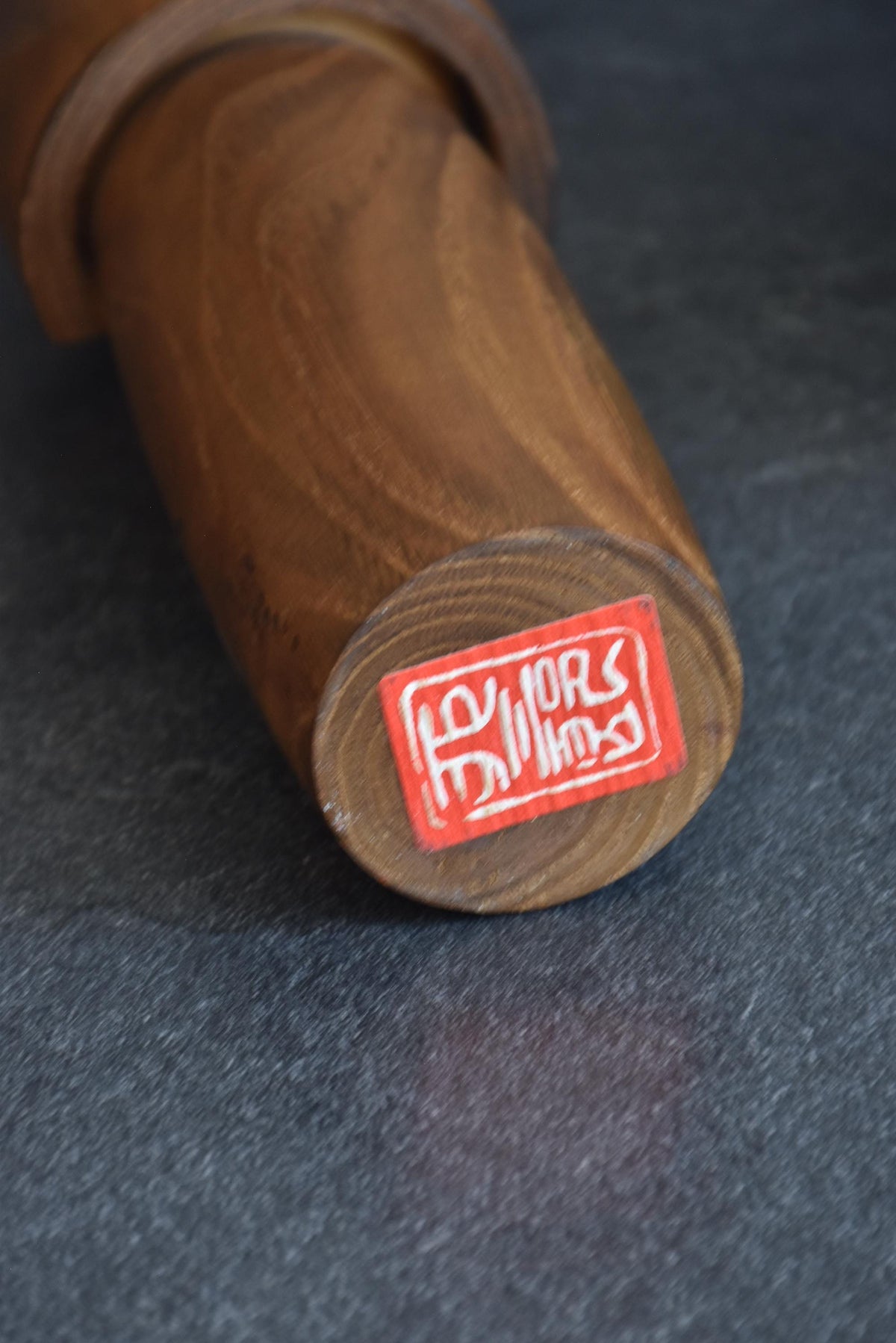 Usaburo kokeshi doll base showing the red maker sticker