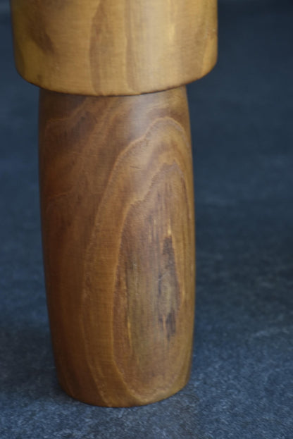 Usaburo kokeshi doll midsection showing the natural wood grain texture