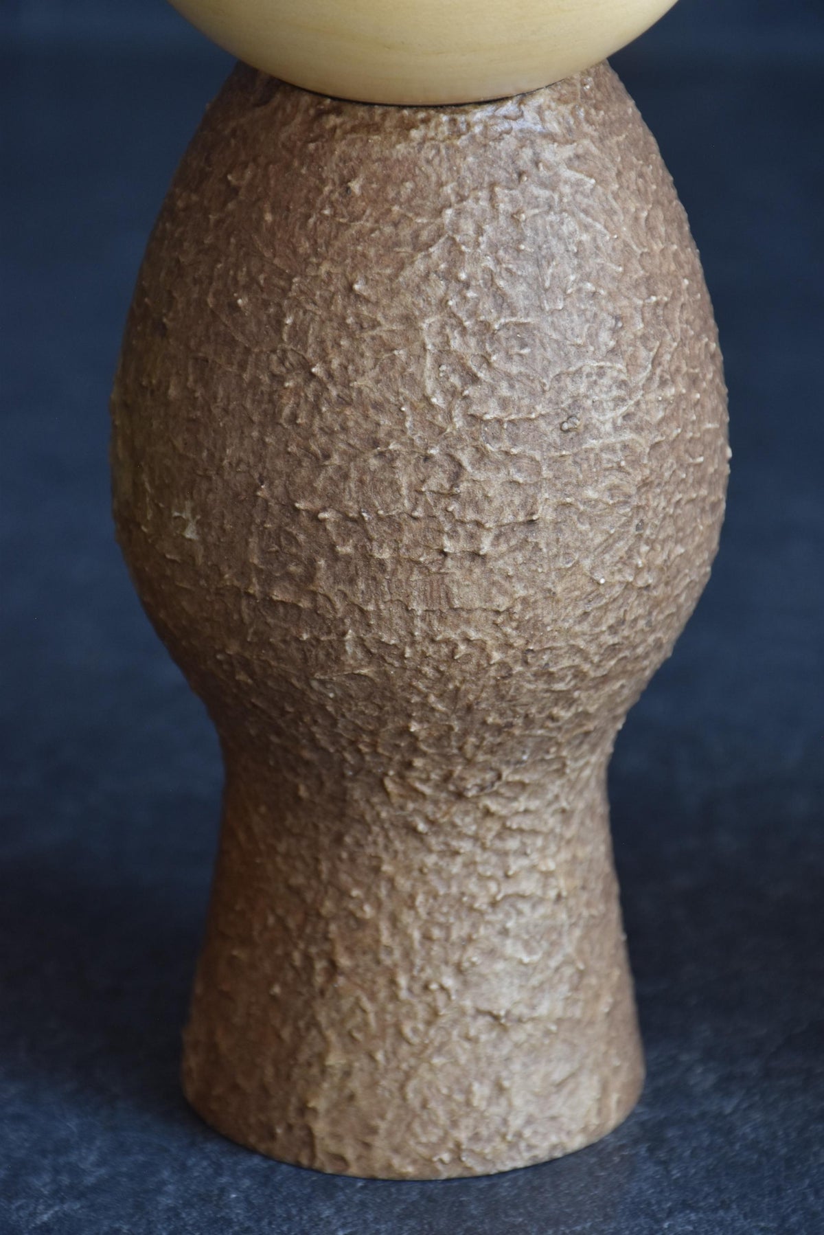 Masao Watanabe Sosaku Kokeshi Doll Mushin close up of textured brown wooden body craftsmanship