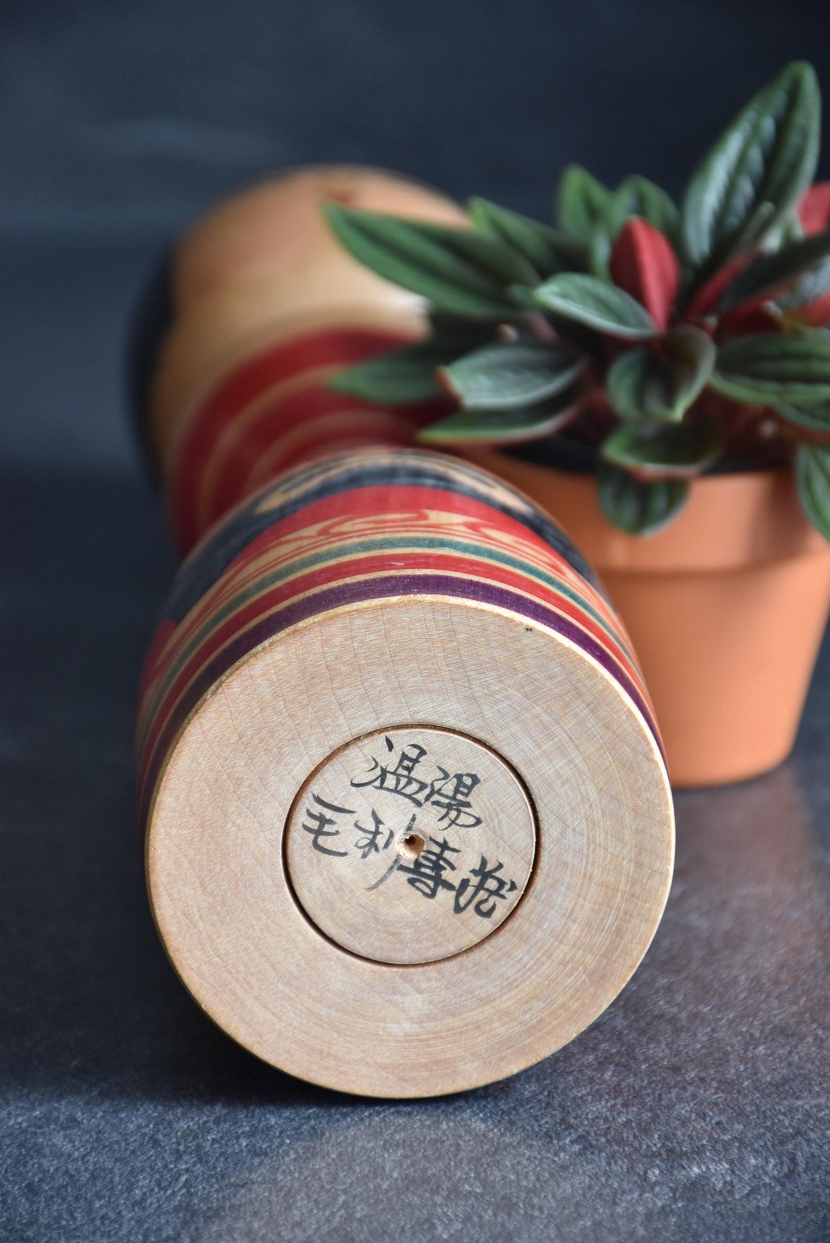 Senzo Mori Tsugaru kokeshi doll base showing the signature and maker marks