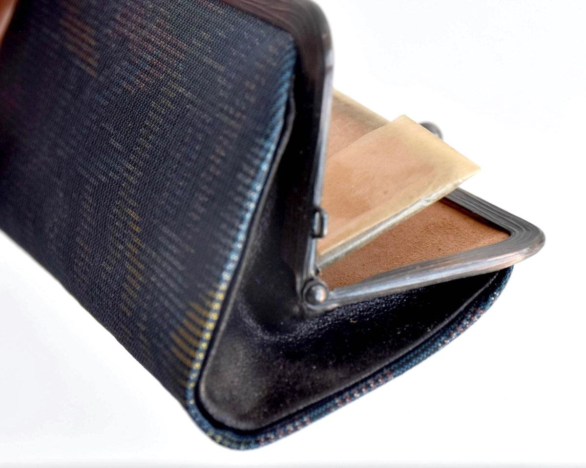 Blue Oshima Tsumugi Silk Gamaguchi Coin Purse shown open to reveal the light brown interior lining and pockets.