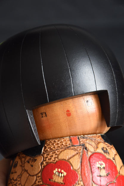 Kazuo Takamizawa kokeshi face angle close-up showing the minimalist features and wood grain