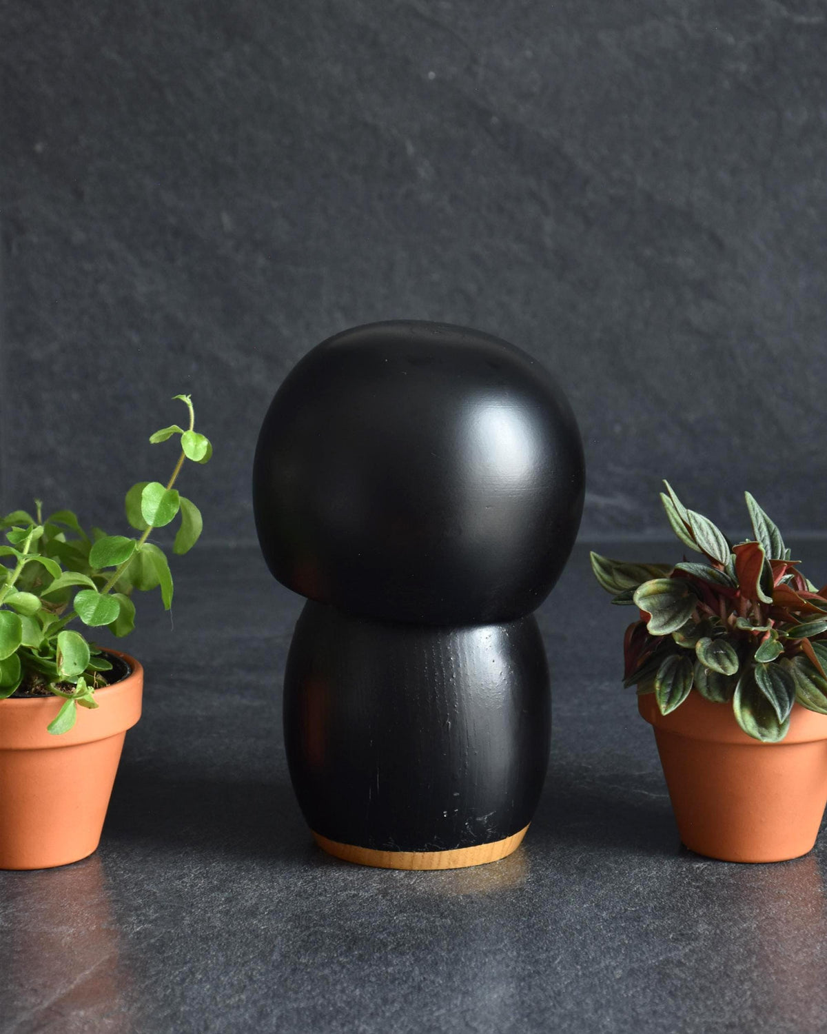 Kazuo Takamizawa kokeshi doll viewed from the side showcasing the rounded wooden shape