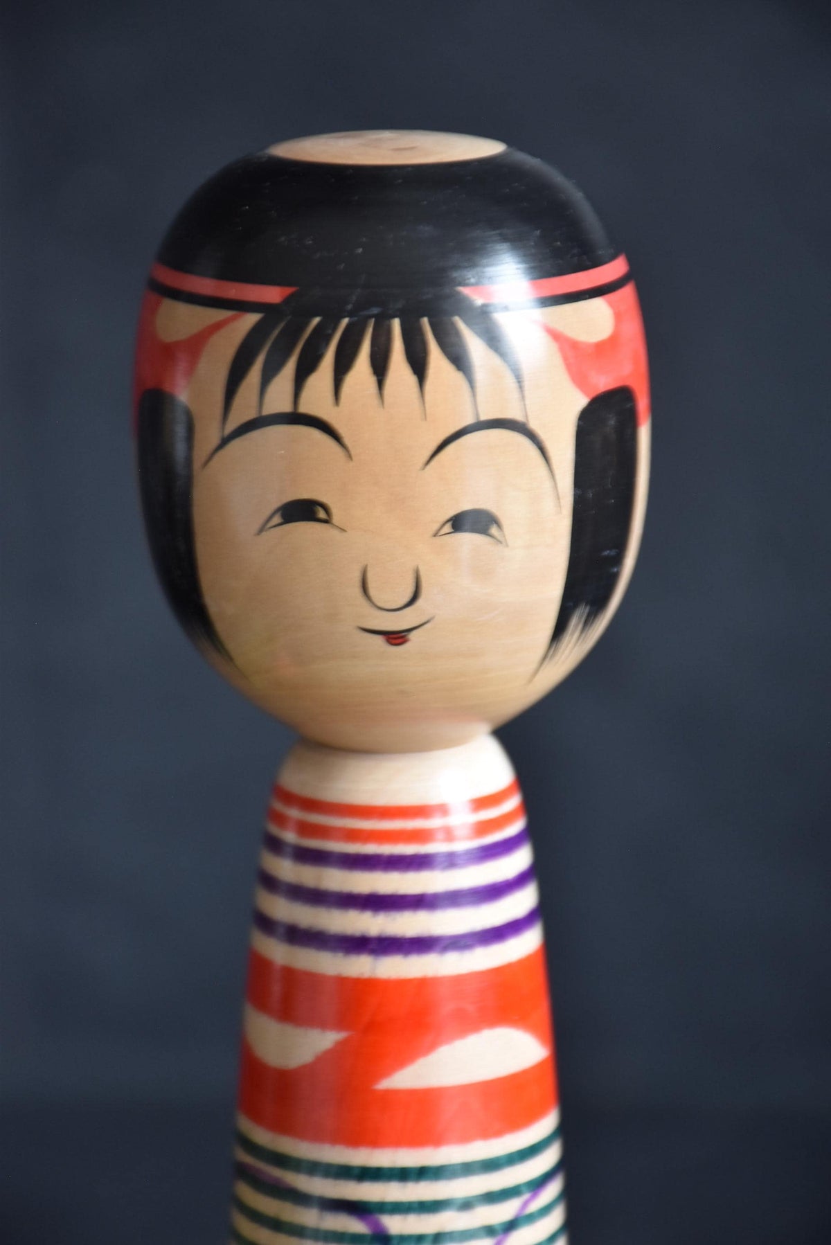 Tsuchiyu kokeshi doll alternative facial view highlighting traditional painted features