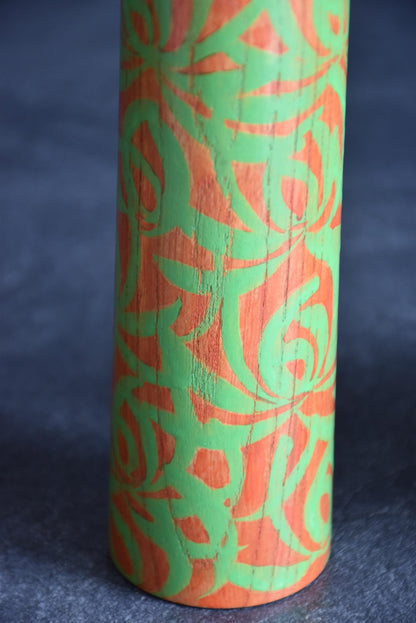 Issetsu Kuribayashi sosaku kokeshi doll showing lower body with green flowing floral design