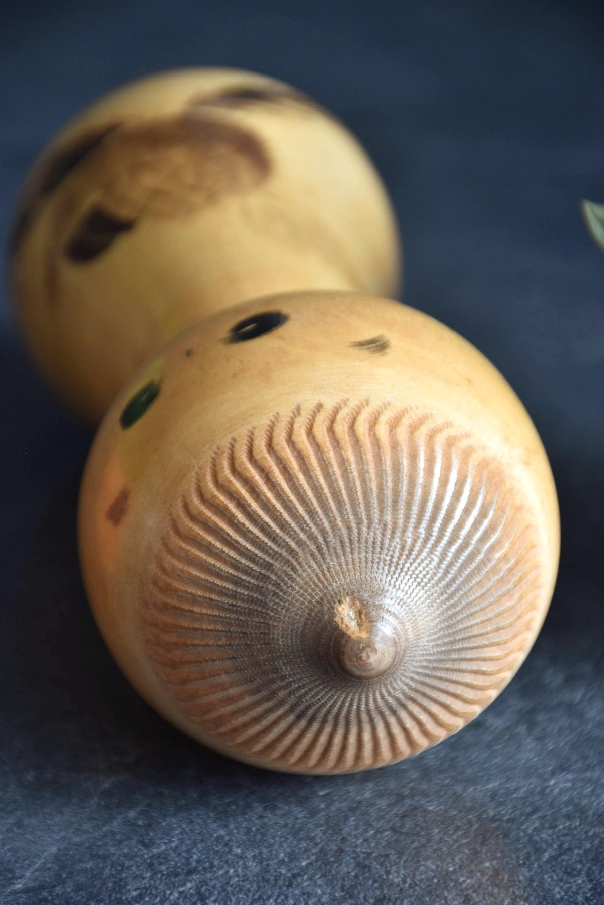 Masao Watanabe kokeshi doll top of head showing peaked hairstyle and chip