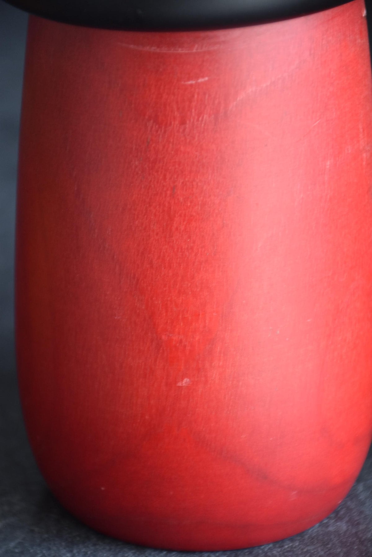 Masae Fujikawa kokeshi doll close-up of the red wooden body with light surface wear