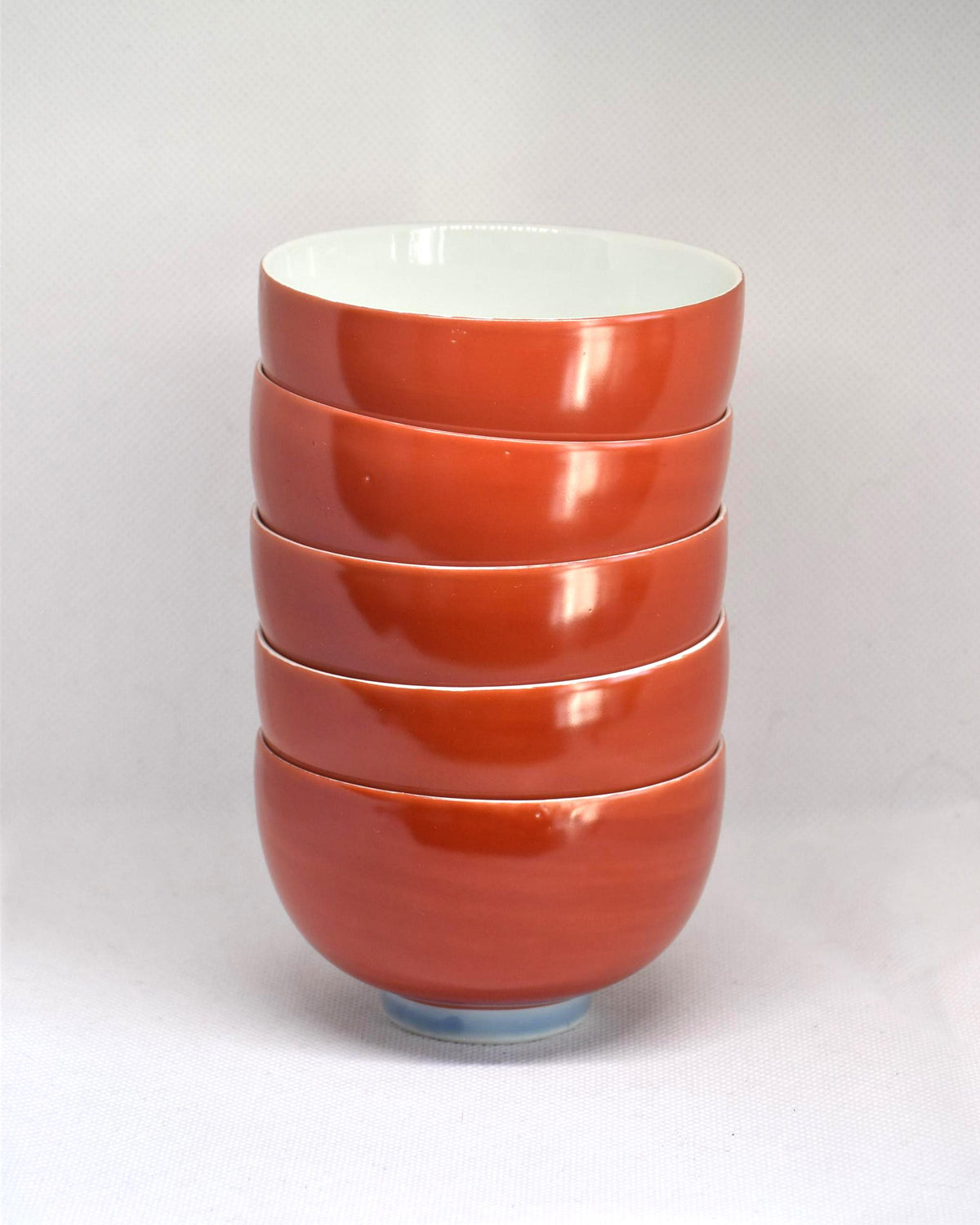 Koransha tea cup set featuring a single red and white porcelain bowl viewed from the side