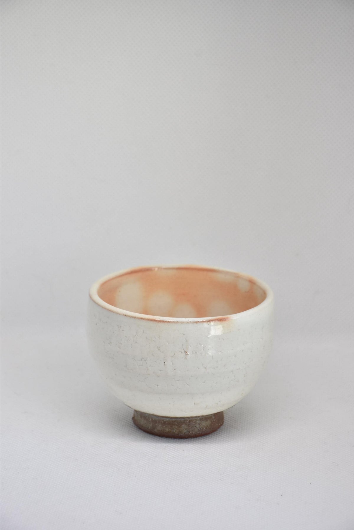 Set Of 5 White Kumidashi Teacups single cup detailed view emphasizing the rim and glazed exterior body