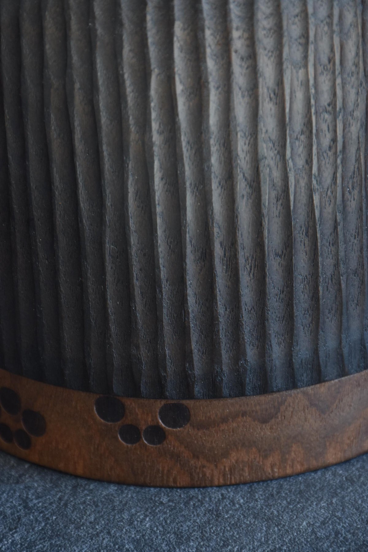 Sanpei Yamanaka kokeshi close-up of dark textured hair panel over wooden body