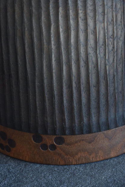 Sanpei Yamanaka kokeshi close-up of dark textured hair panel over wooden body