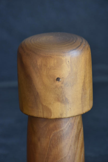 Usaburo kokeshi doll head detail showing the smooth rounded top and wood knot