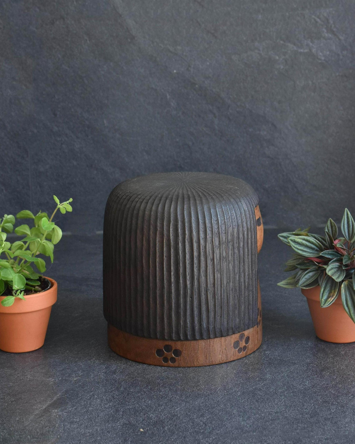 Sanpei Yamanaka kokeshi side view highlighting the dark carved wooden hair texture