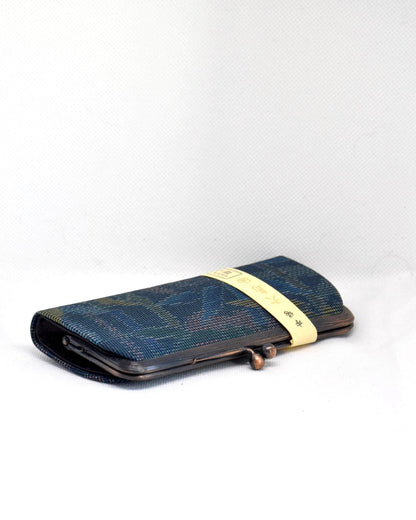 Blue Oshima Tsumugi Silk Gamaguchi Coin Purse angled view showing the metal clasp and textured silk fabric.