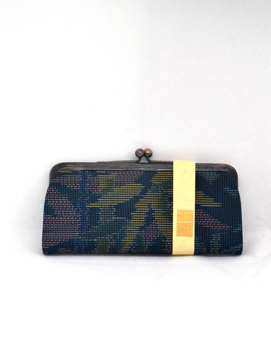 Blue Oshima Tsumugi Silk Gamaguchi Coin Purse featuring traditional Japanese mud-dyed fabric and metal clasp.