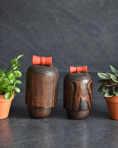 Sosaku Kokeshi Pair showing the plain back of both dark wooden dolls