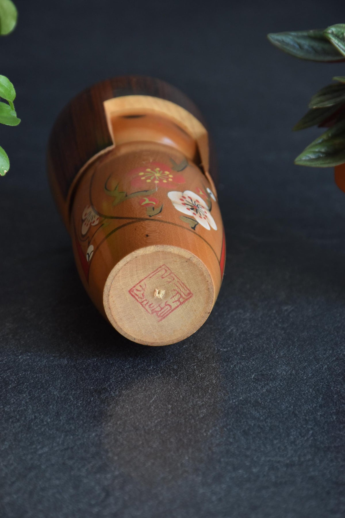 Kojo Tanaka Sosaku Kokeshi doll base showing the artisan stamp and wooden peg