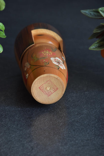Kojo Tanaka Sosaku Kokeshi doll base showing the artisan stamp and wooden peg