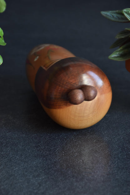 Kojo Tanaka Sosaku Kokeshi doll top view focusing on the two-sphere hair ornament