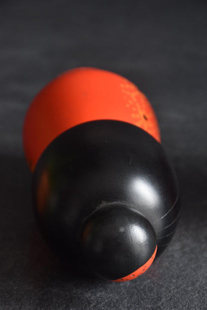 Kazuo Takamizawa kokeshi doll top view, showing the black bob and rounded topknot structure