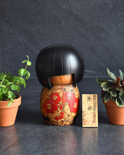 Kazuo Takamizawa Sosaku Kokeshi Tsubaki Camelia Doll with red and orange kimono patterns