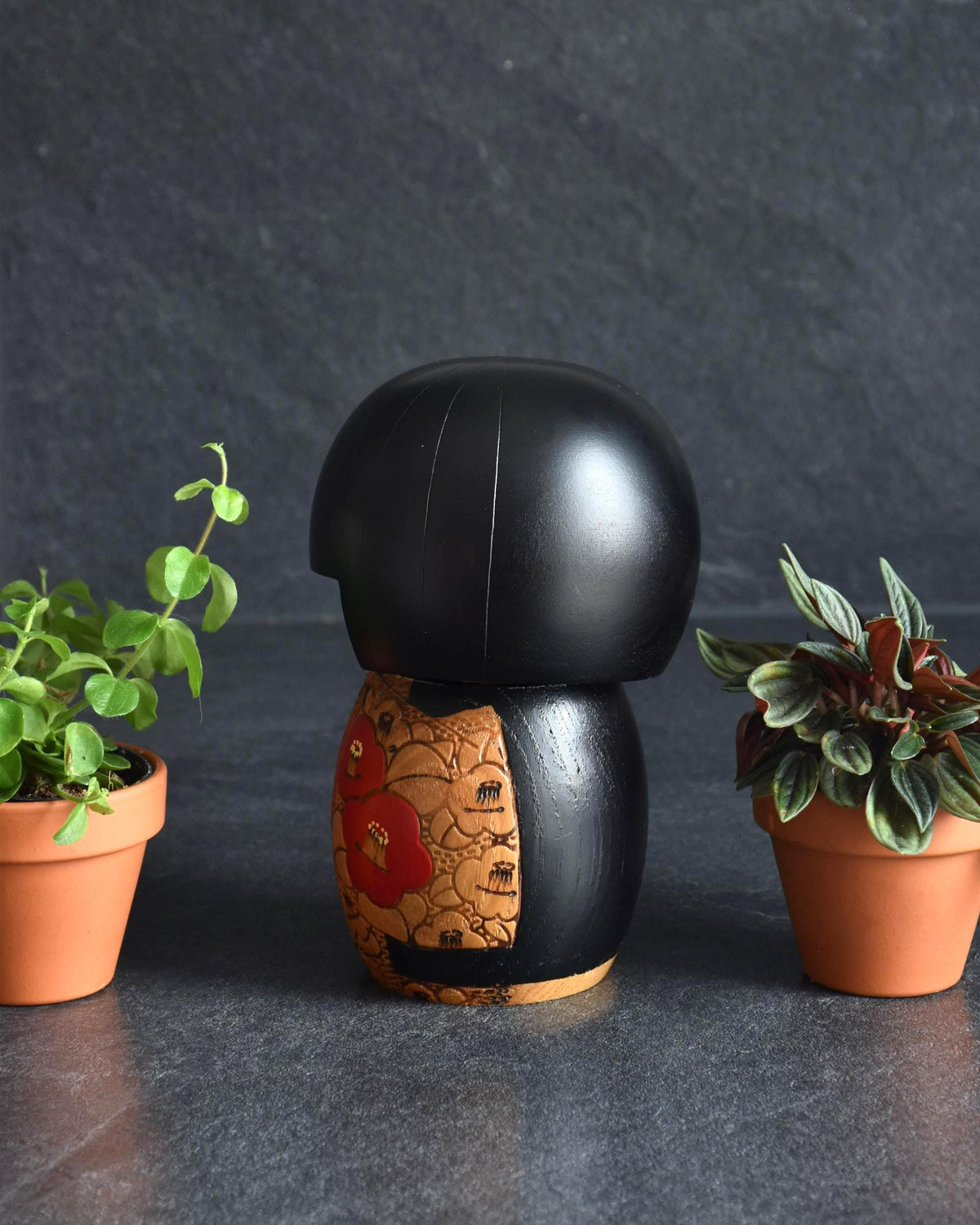 Kazuo Takamizawa kokeshi doll viewed from the back showing its black bob hair and wooden body