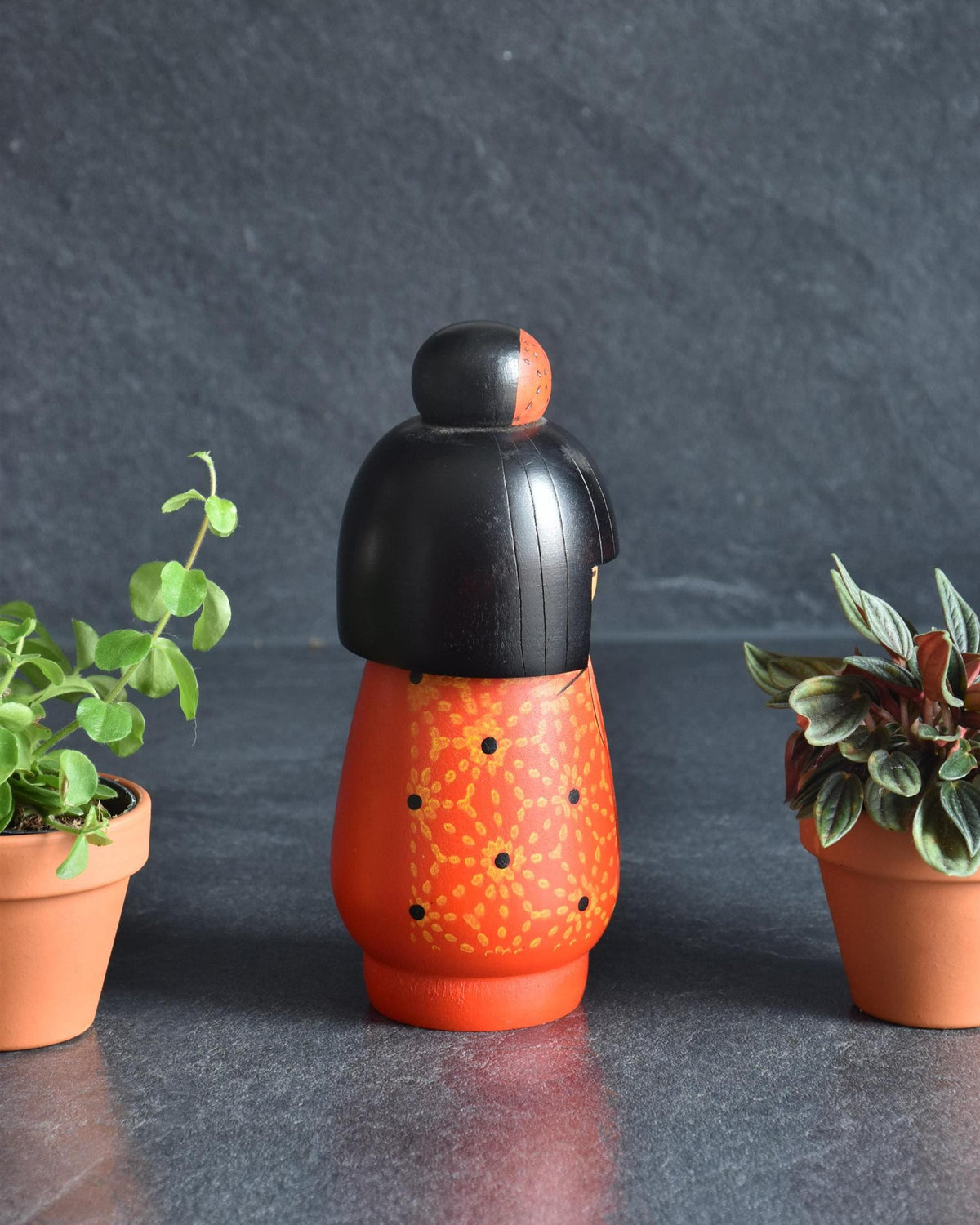Kazuo Takamizawa kokeshi doll viewed from the other side, showing carved orange body details