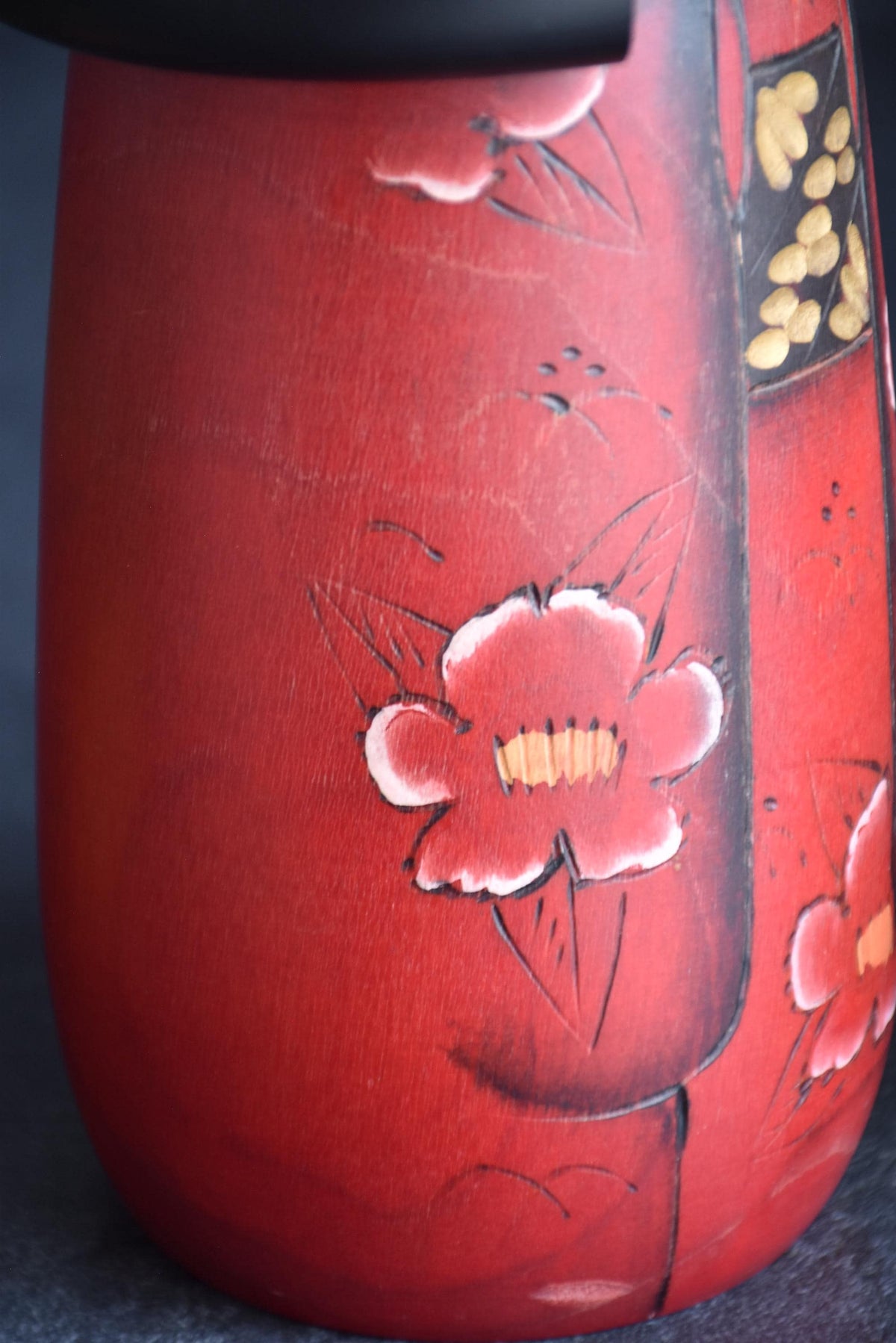 Masae Fujikawa kokeshi doll close-up showing the textured dark obi belt and kimono folds