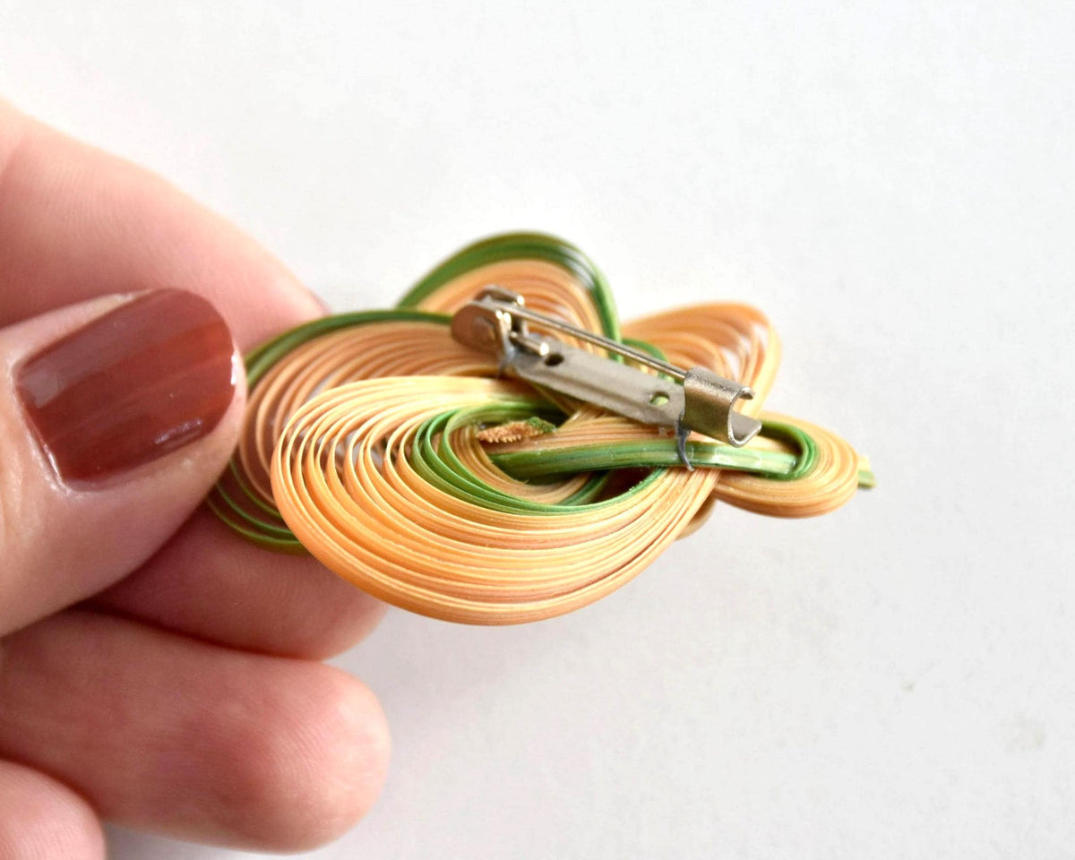 Hand-Woven Bamboo Knot Brooch In Beige And Green close-up of the metal pin