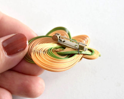 Hand-Woven Bamboo Knot Brooch In Beige And Green close-up of the metal pin