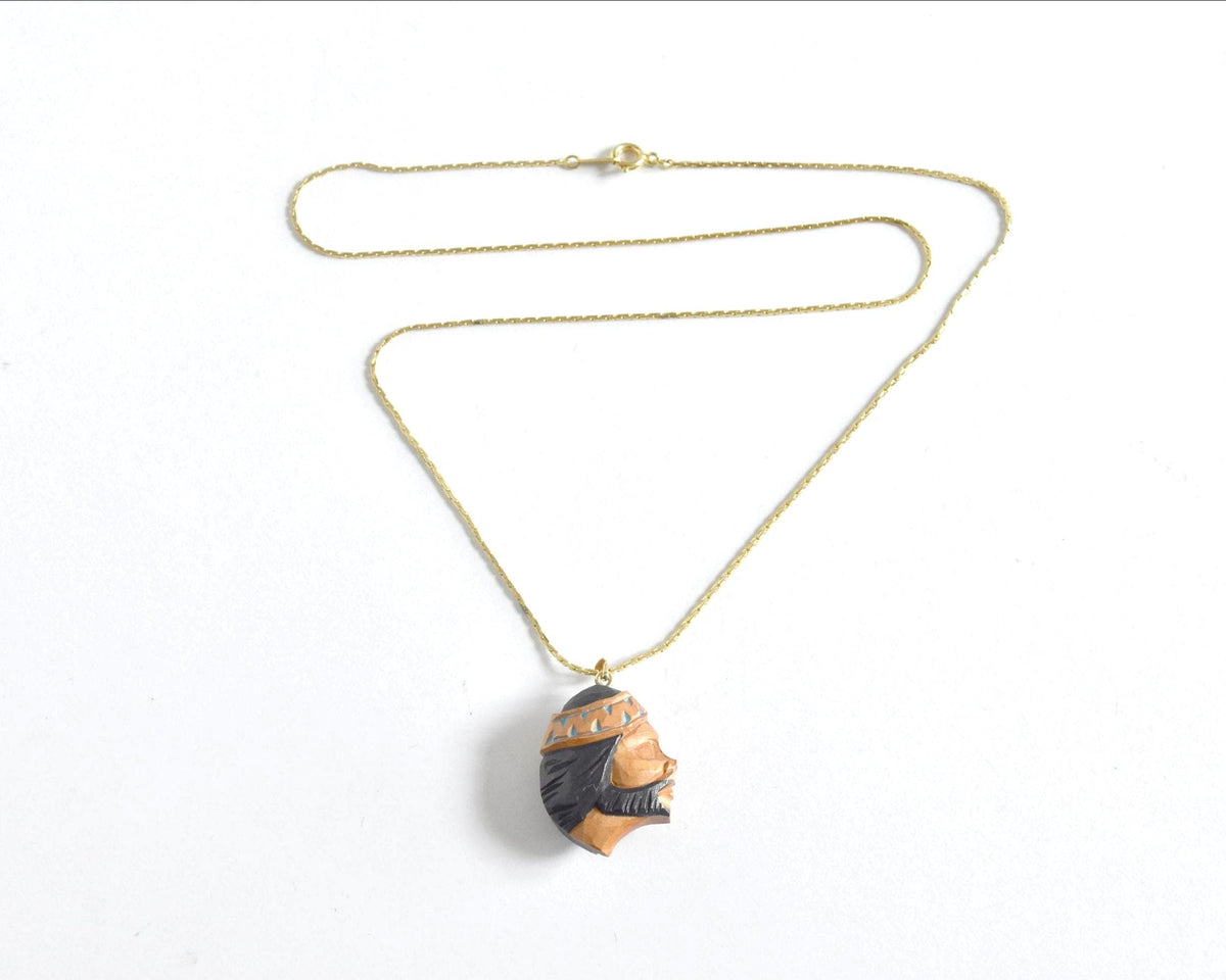 Ainu handcarved wood pendant necklace full view with gold-tone chain