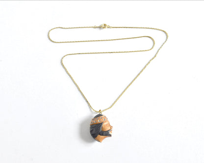Ainu handcarved wood pendant necklace full view with gold-tone chain