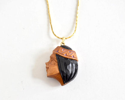 Ainu handcarved wood pendant necklace showing the woman profile portrait